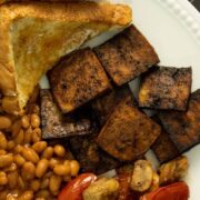 English-style breakfast on a white plate with vegan Canadian bacon