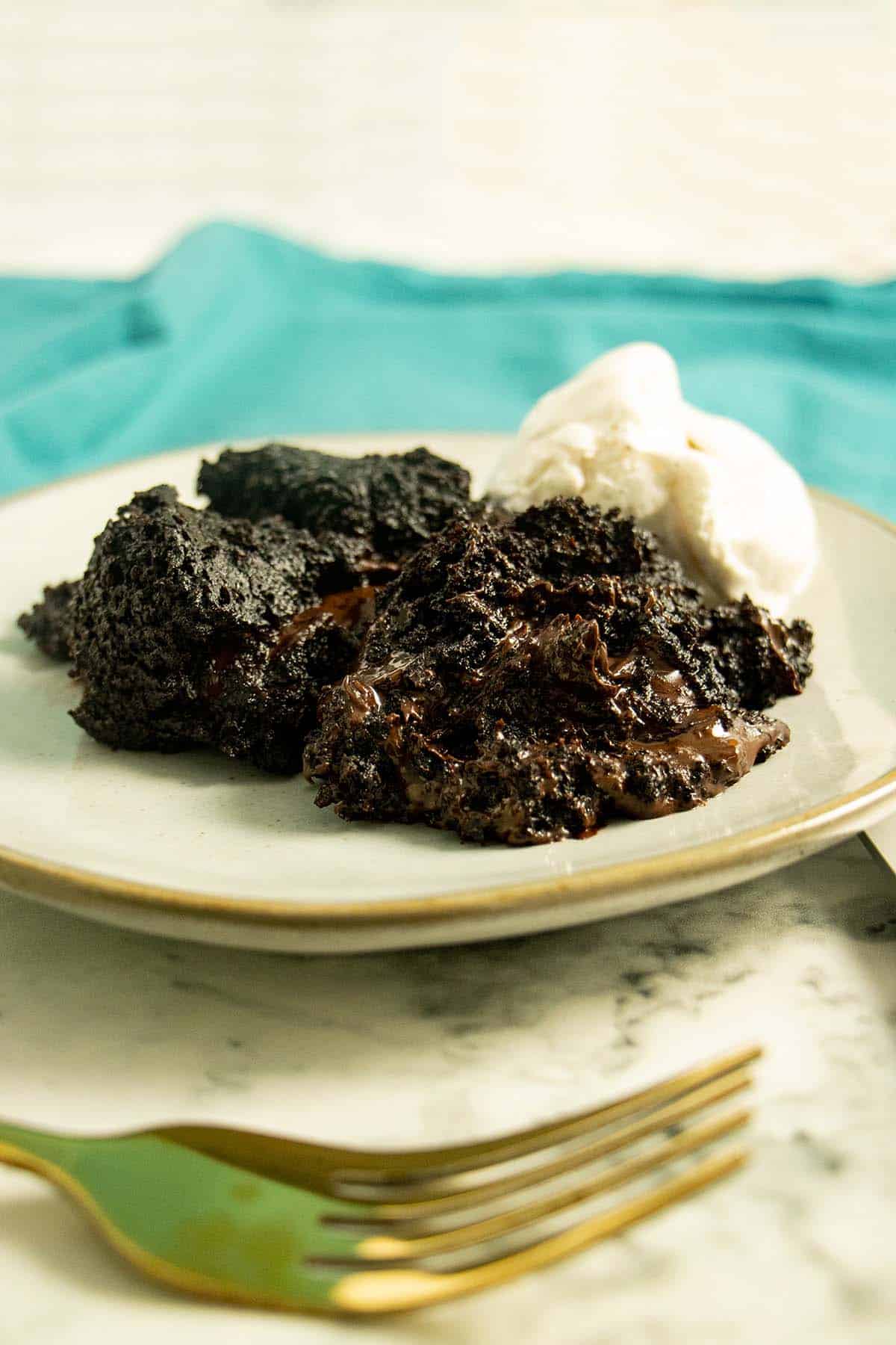 Instant Pot brownies on a plate with vanilla ice cream