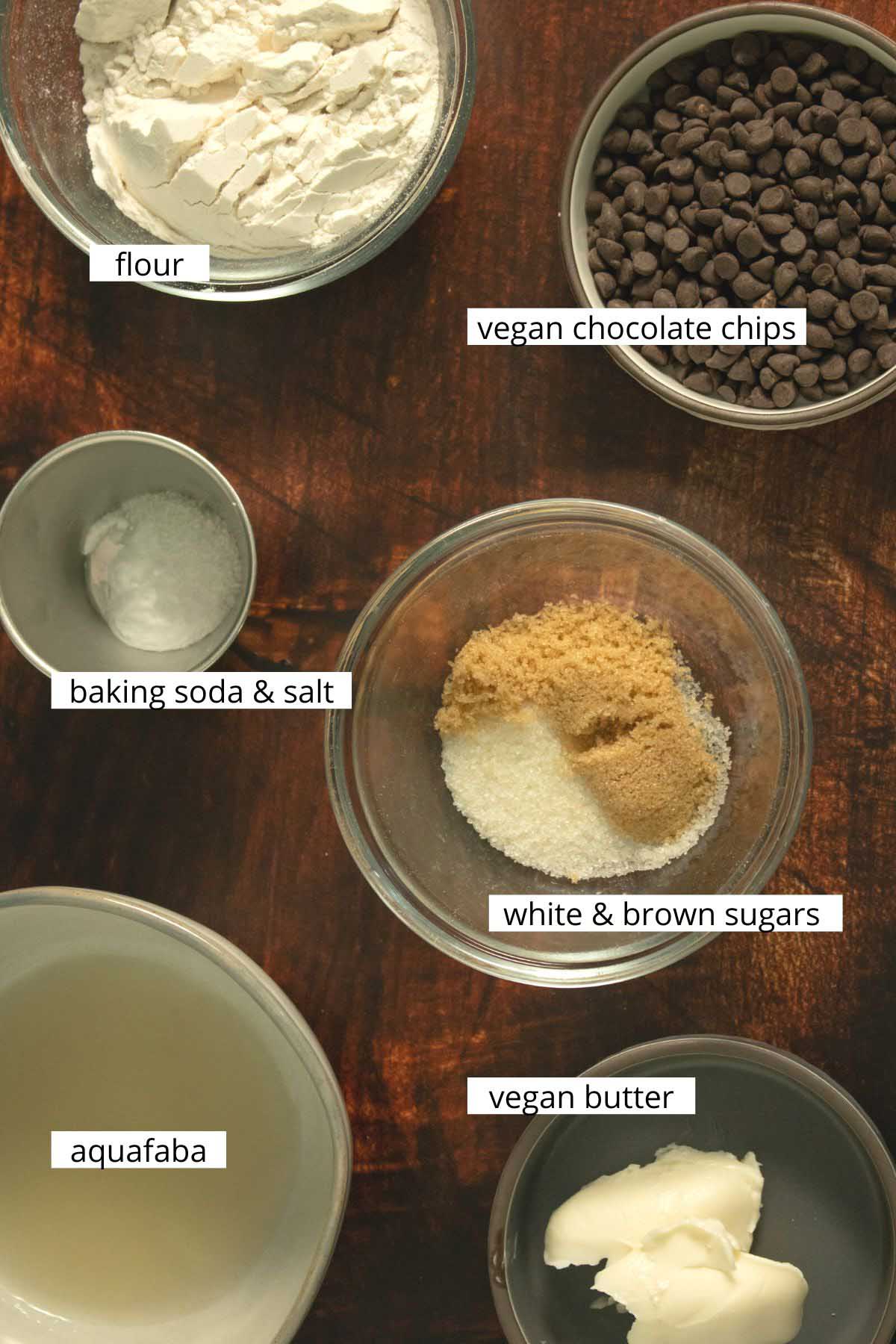 vegan air fryer cookies ingredients on a wooden table. Each ingredient labeled with text.