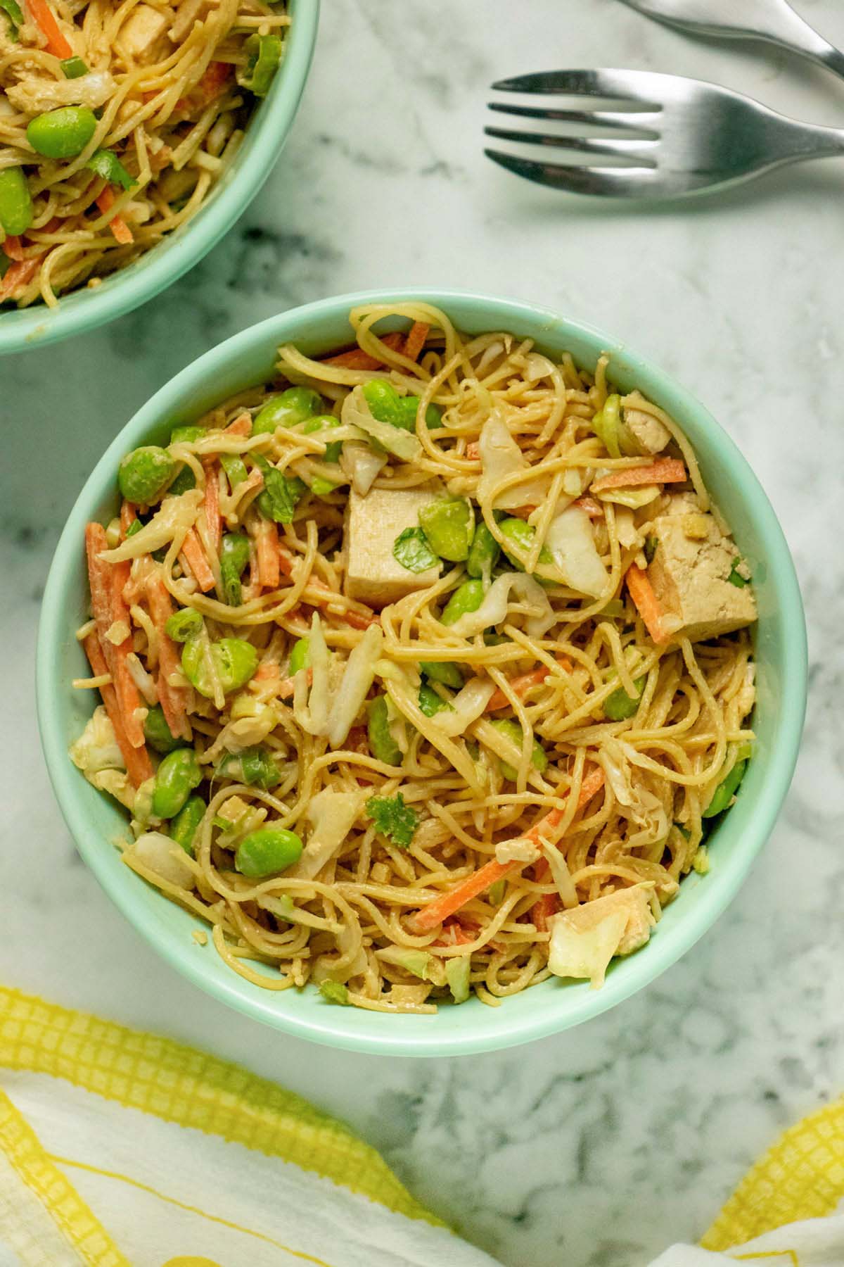 bowls of cold peanut noodles on a white table