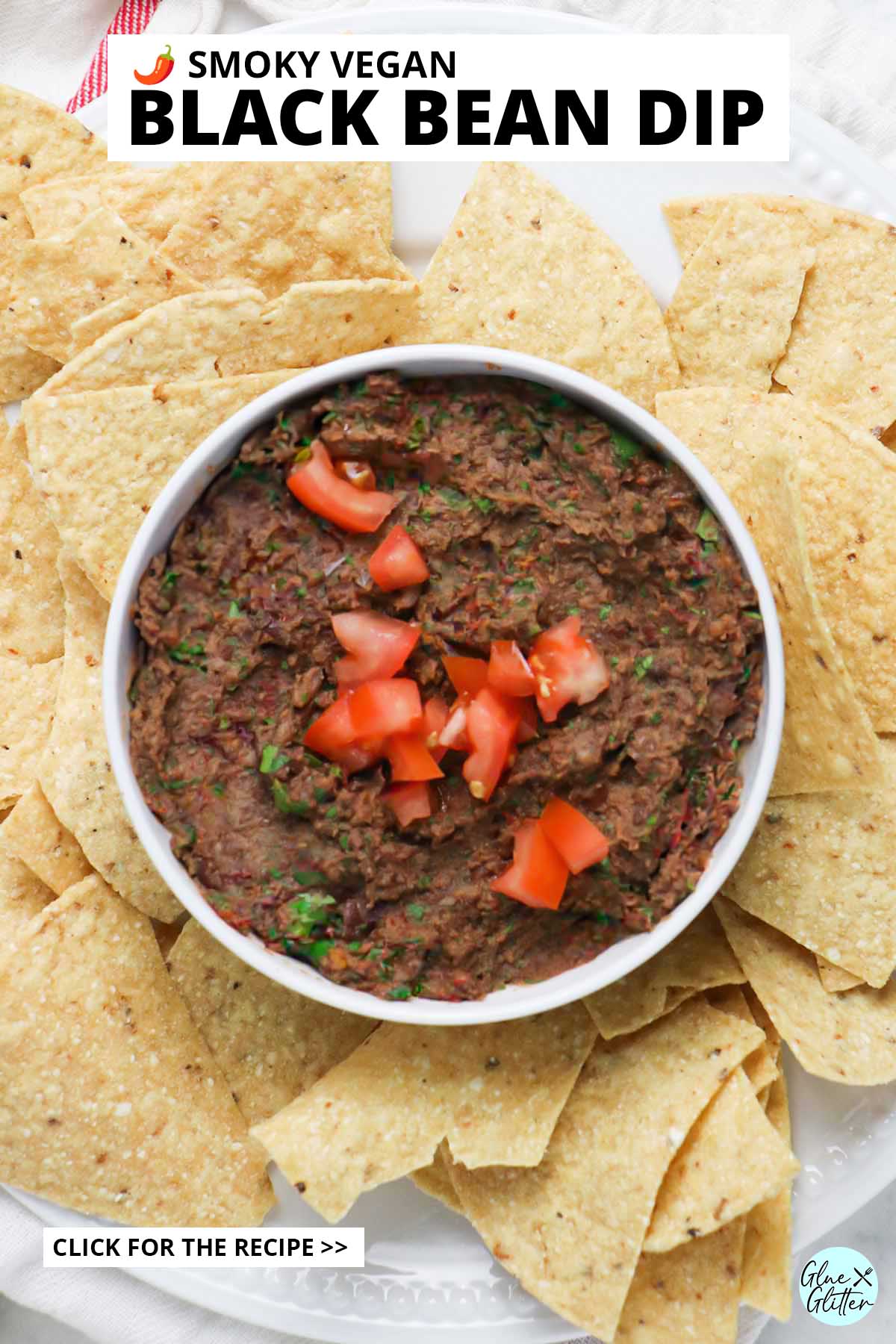 vegan black bean dip in a bowl surrounded by tortilla chips, text overlay