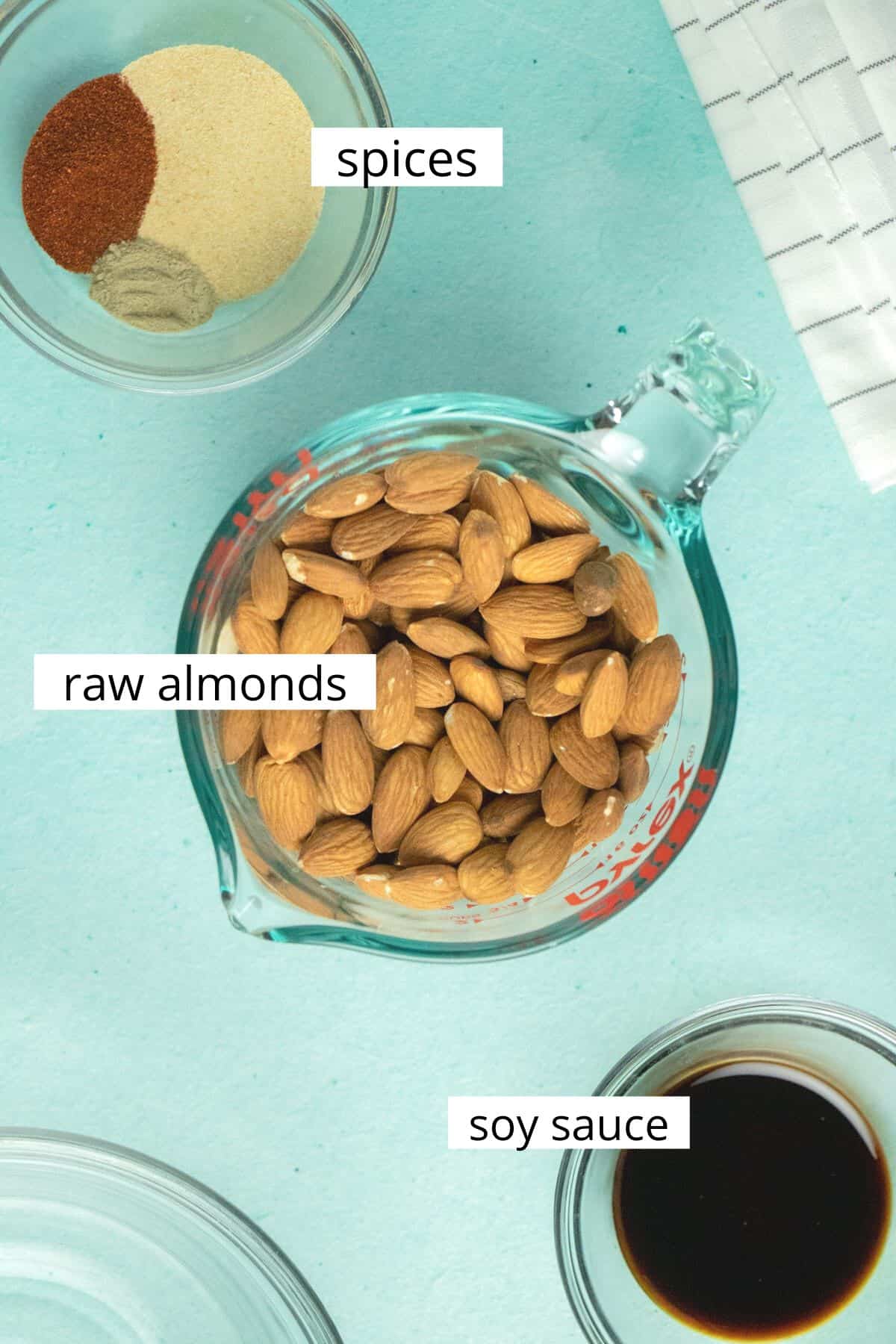 image collage showing spices, almonds, and soy sauce in bowls on a blue table with text labels on each