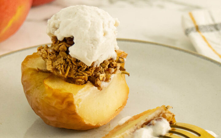air fryer baked apples on a plate with vegan vanilla ice cream on it