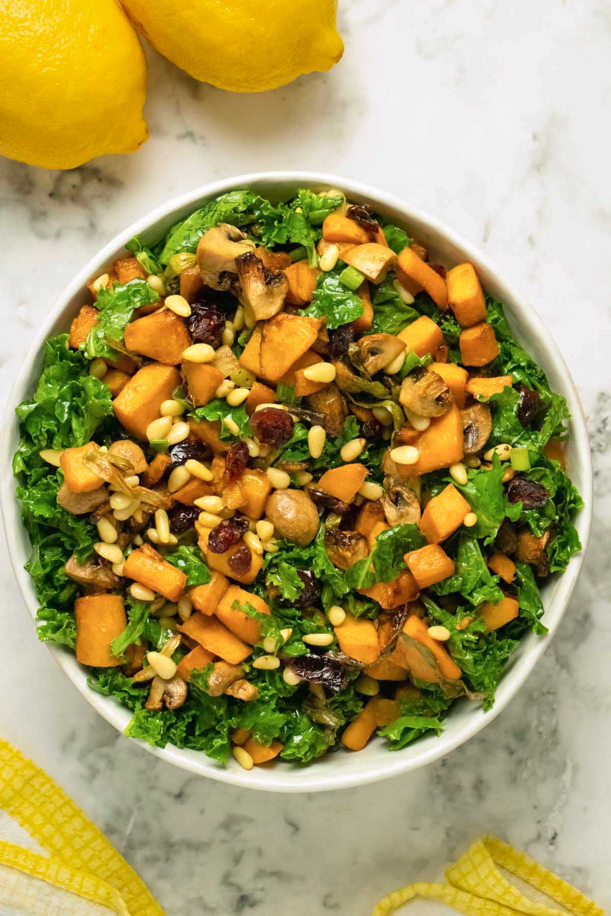 butternut squash kale salad in a white bowl