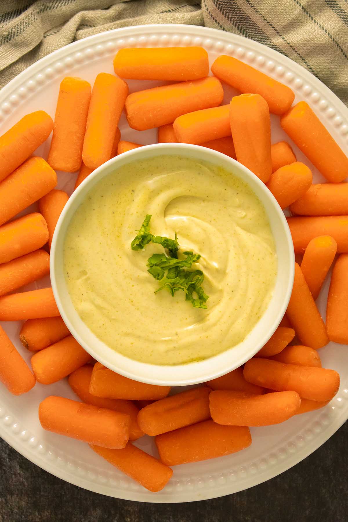 bowl of curry mayo with carrots to dip