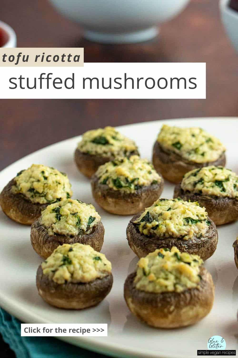 tofu stuffed mushrooms on a white serving plate, text overlay reads, "Tofu Ricotta Stuffed Mushrooms"