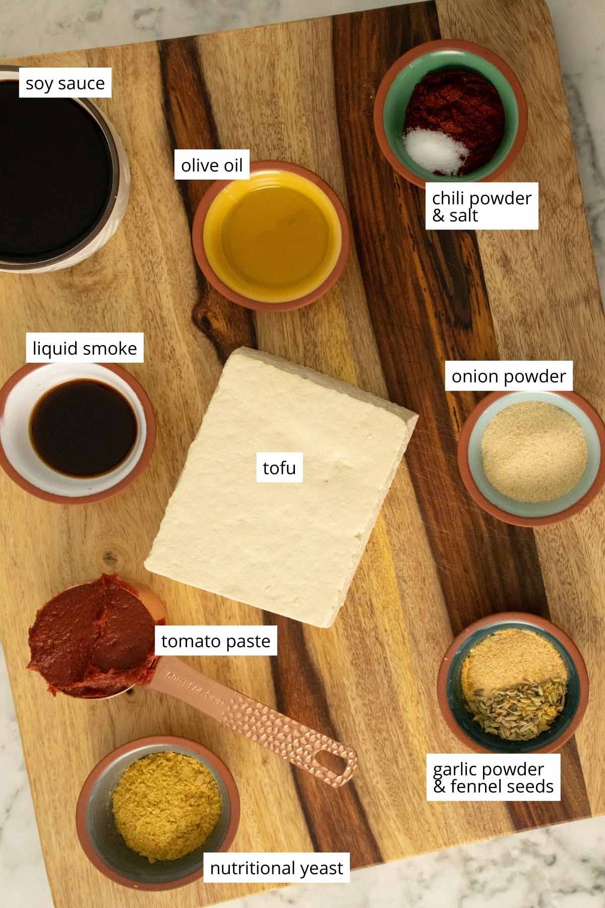 photo of tofu and sausage seasonings on a wooden cutting board