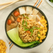 bowl of creamy vegan miso ramen with tofu, bok choy, and other veggies