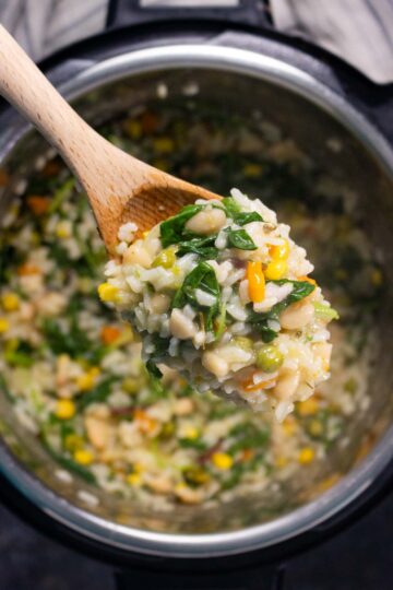 wooden spoon serving Instant Pot vegan risotto
