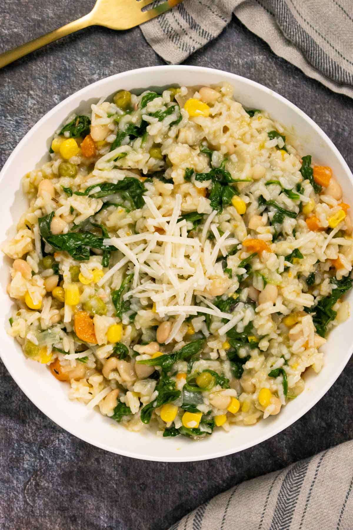 vegan Instant Pot risotto in a bowl topped with some vegan parmesan
