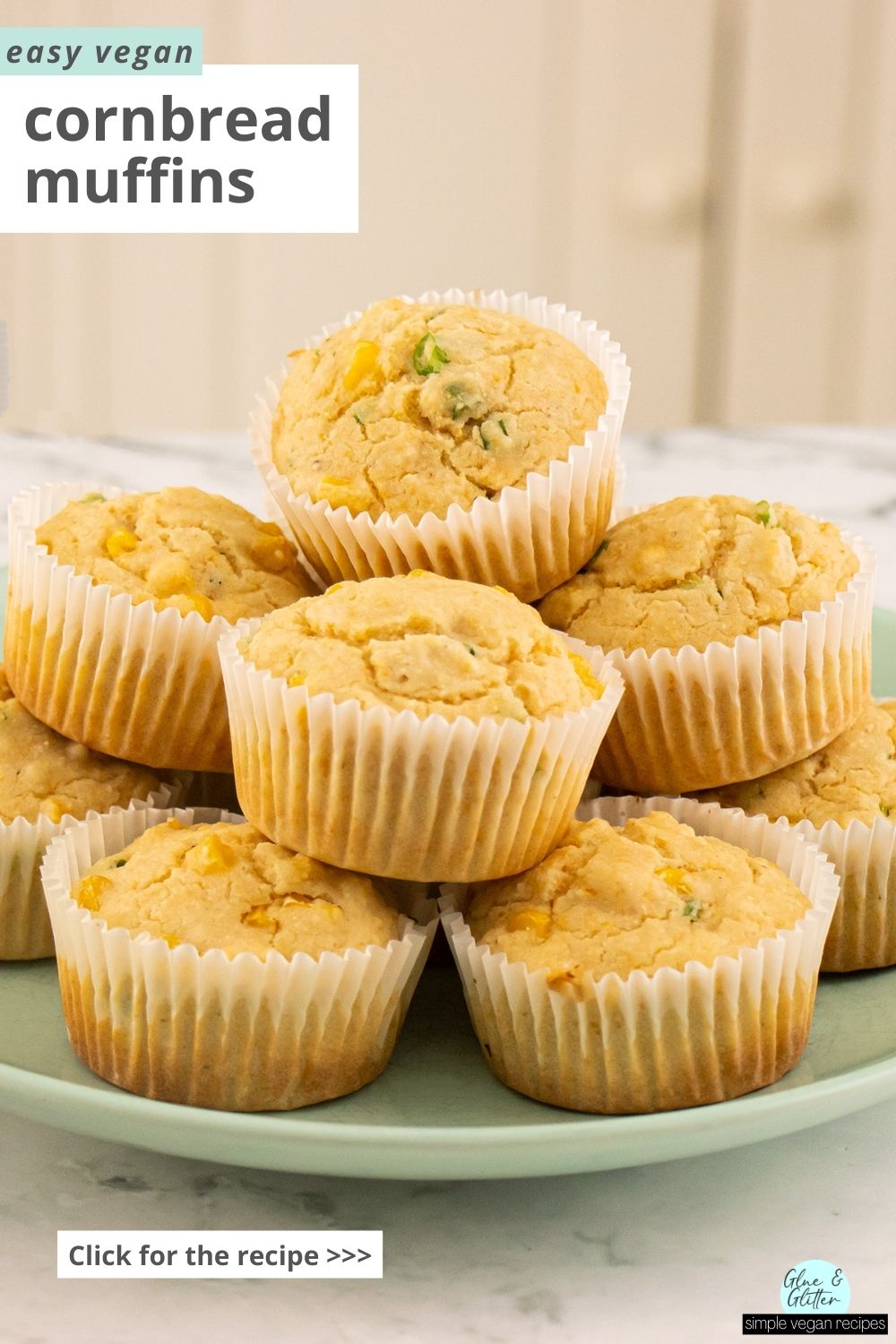 vegan cornbread muffins piled onto a blue plate, text overlay