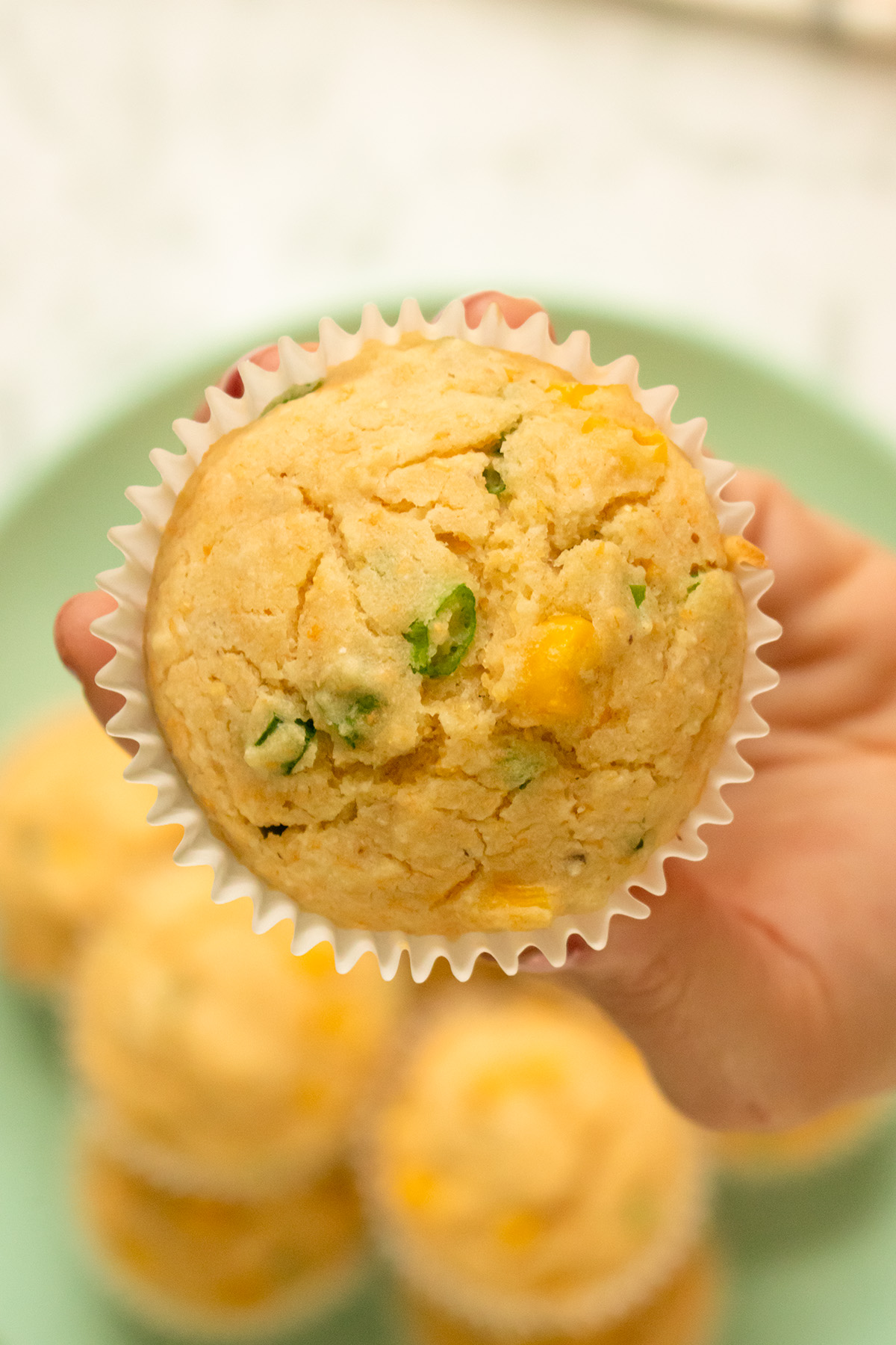 close-up of a vegan corn muffin, so you can see the texture of the top