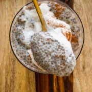 close-up of a spoonful of chai chia pudding resting on a glass