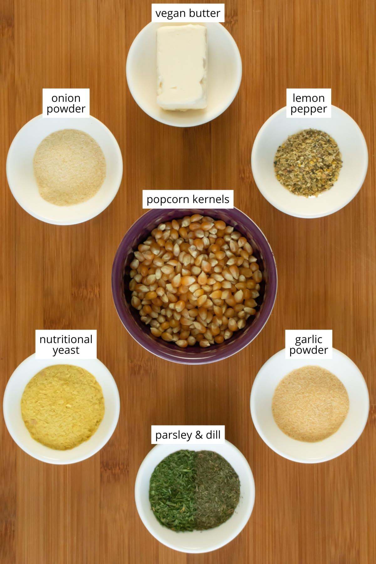 image collage of popcorn and seasonings in bowls on a wooden table