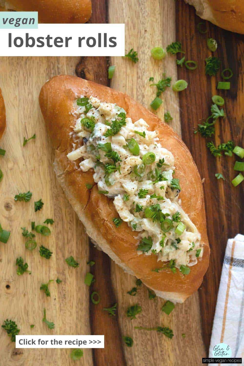 vegan lobster rolls on a wooden tabletop sprinkled with green onion and parsley, text overlay