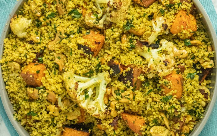 serving bowl of curried couscous salad with roasted vegetables