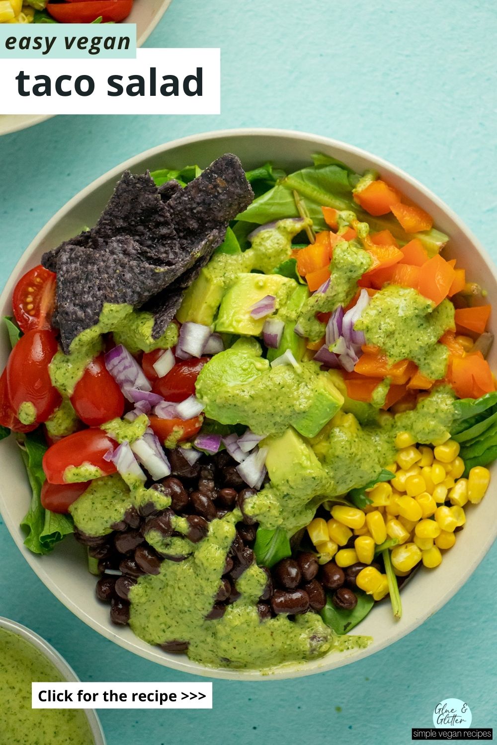 vegan taco salad with veggies, beans, corn, tortilla chips, and chimichurri, text overlay
