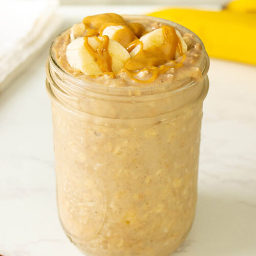 jar of banana and peanut butter overnight oats with slices of banana and a peanut butter drizzle on top