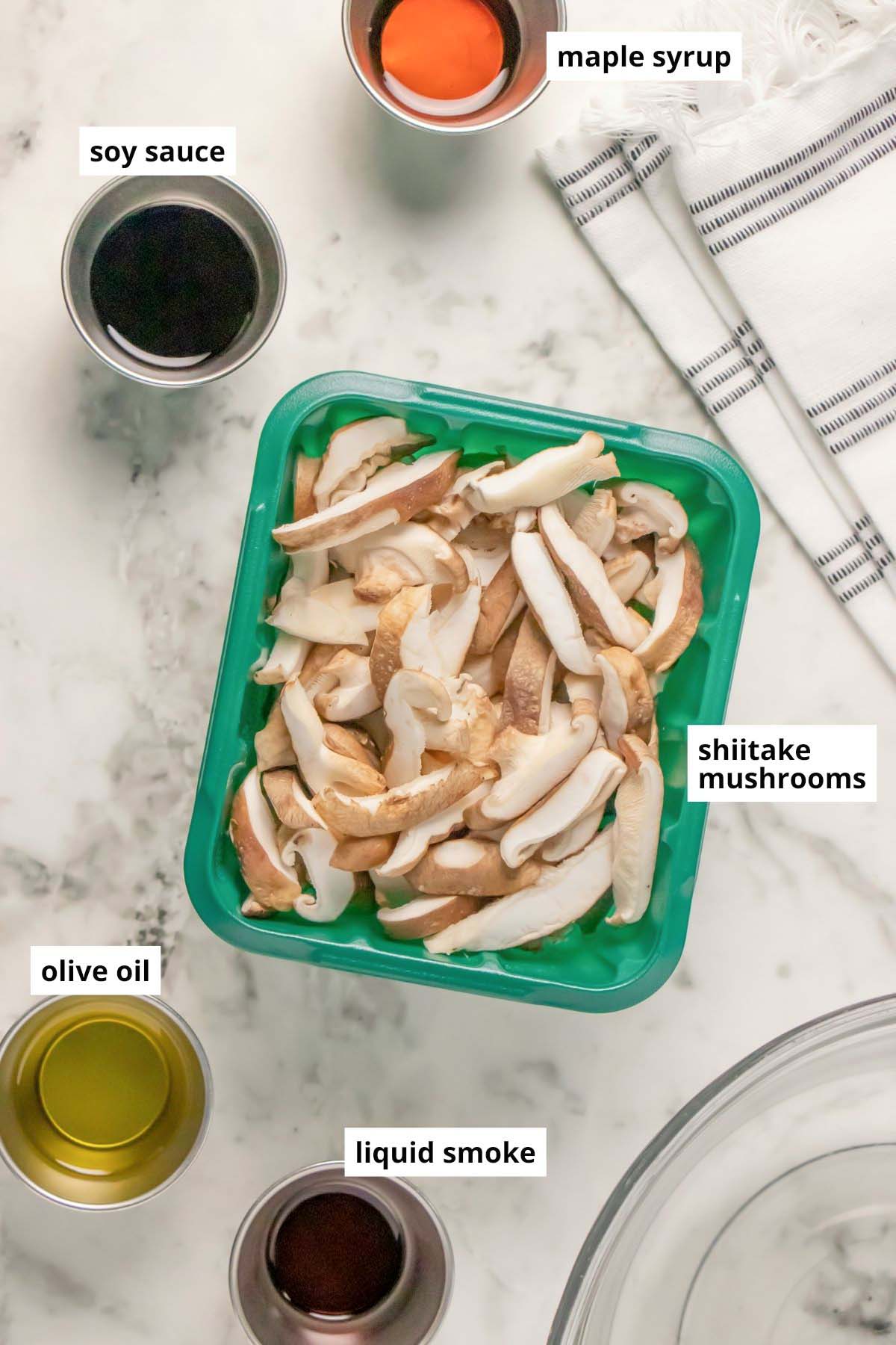 sliced shiitake mushrooms with seasonings in cups on a marble table