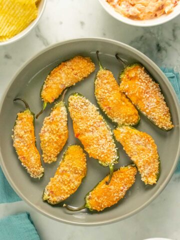 plate of vegan jalapeño poppers with other party foods