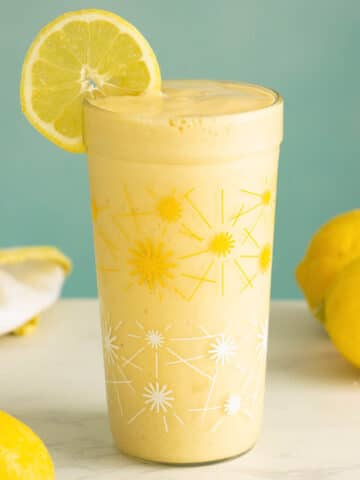 lemon smoothie in a glass with a lemon wheel