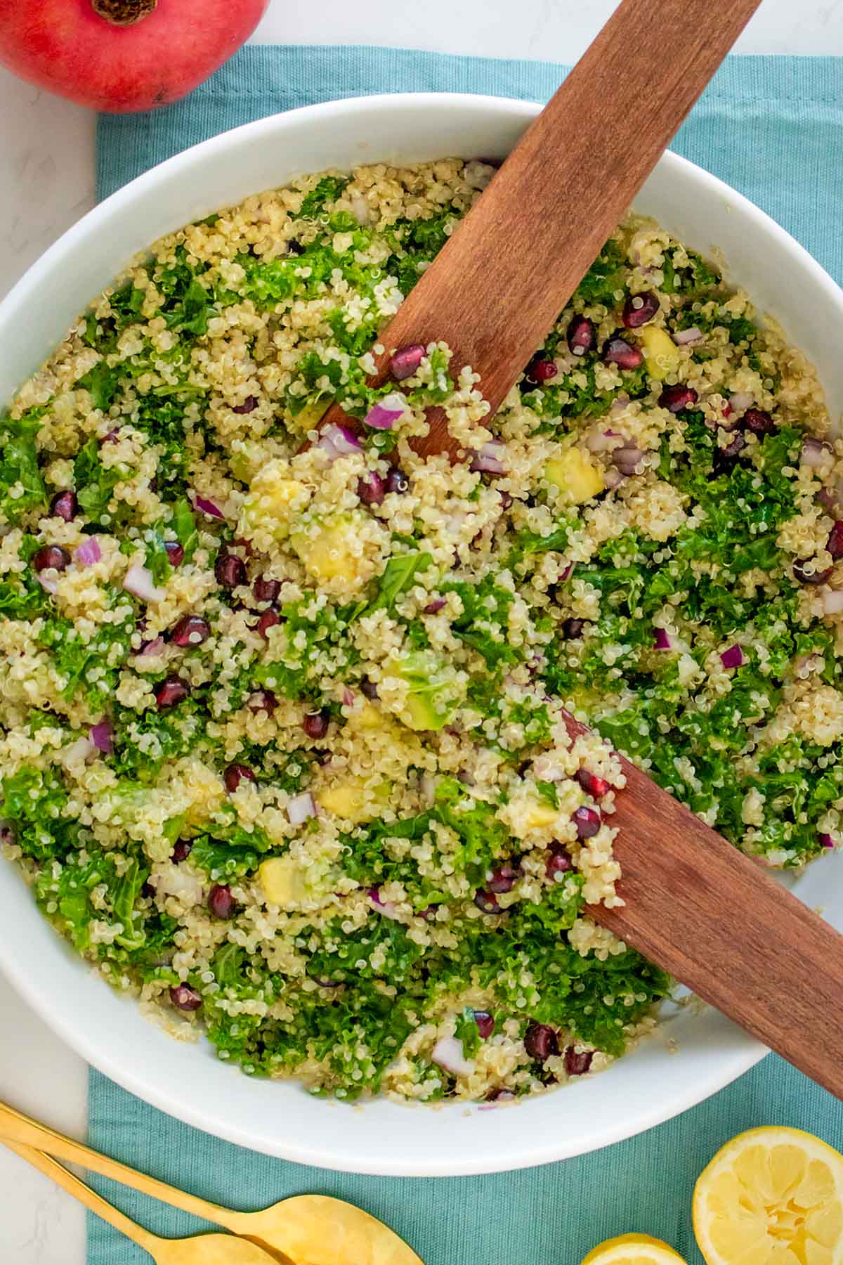 serving bowl of quinoa salad with kale and pomegranate seeds