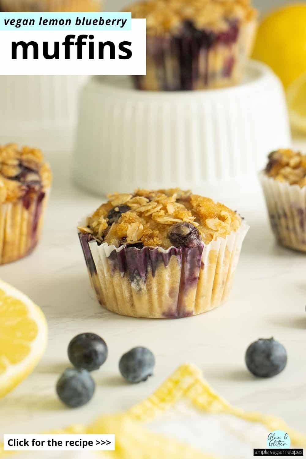 vegan lemon blueberry muffins on a white table with lemon slices and fresh blueberries, text overlay
