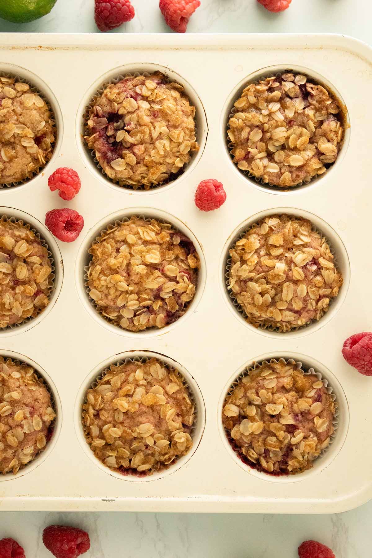 vegan raspberry muffins in the muffin pan after baking