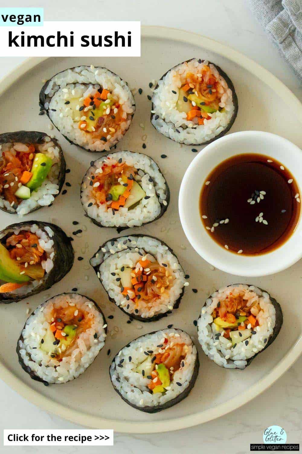 plate of kimchi sushi with sesame seeds and a side of soy sauce, text overlay