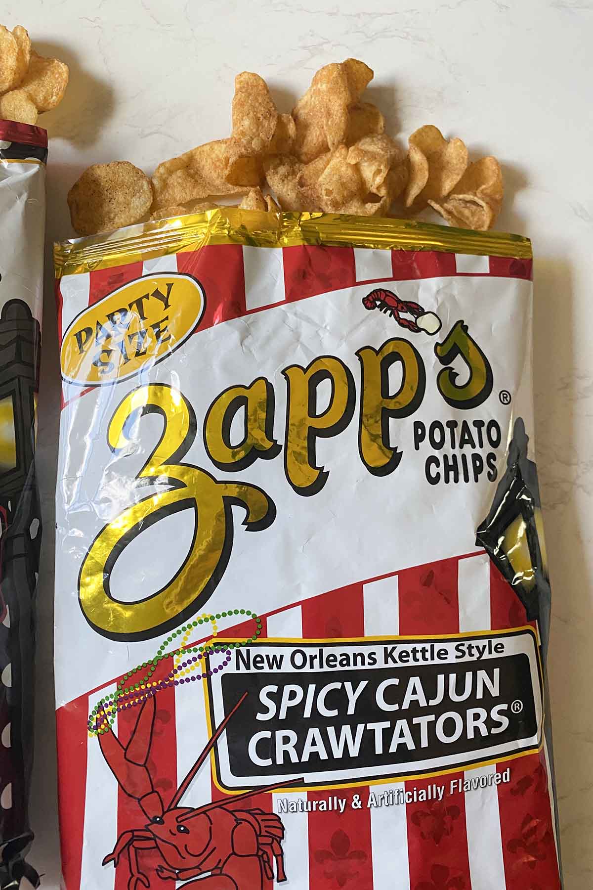 bag of Zapp's Spicy Cajun Crawtators chips with chips spilling out, so you can see what they look like