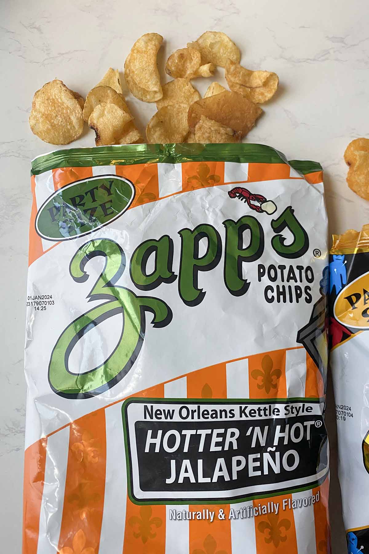 bag of Zapp's Hotter 'n' Hot Jalapeño chips with chips spilling out, so you can see what they look like