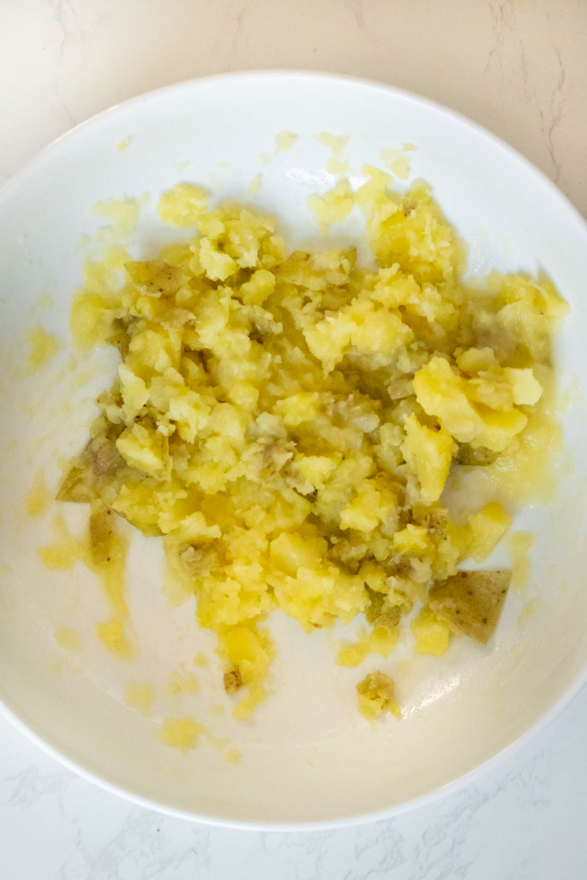 potatoes mashed up with vegan butter in the bowl
