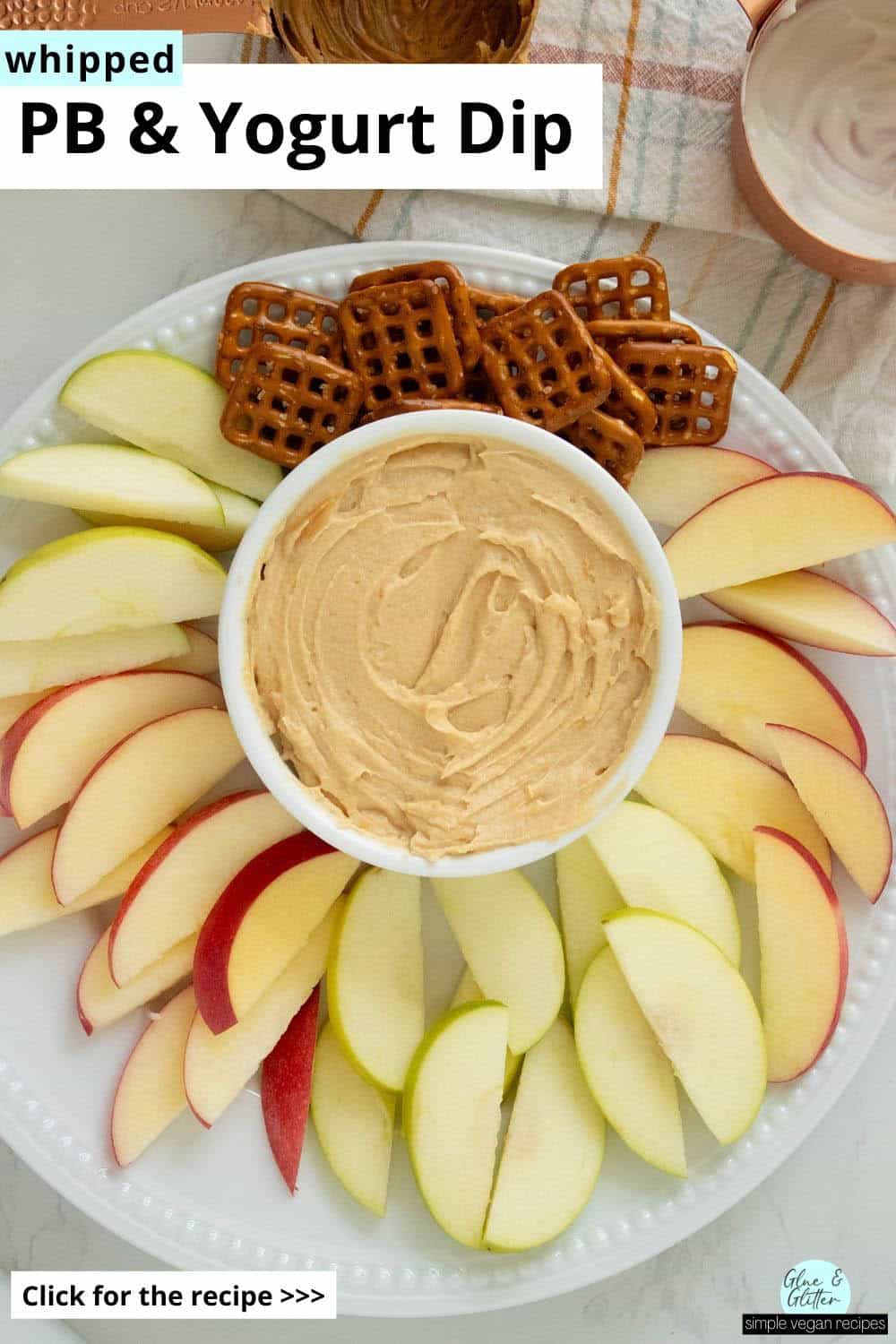 whipped peanut butter yogurt dip with fruit and pretzels for dipping on a white plate, text overlay