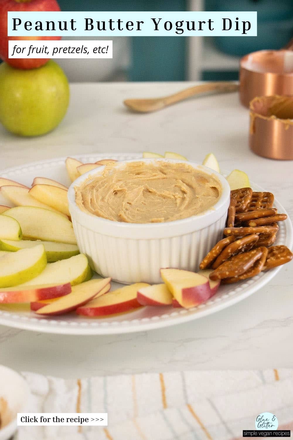 ramekin of peanut butter yogurt dip with apples and pretzels, text overlay