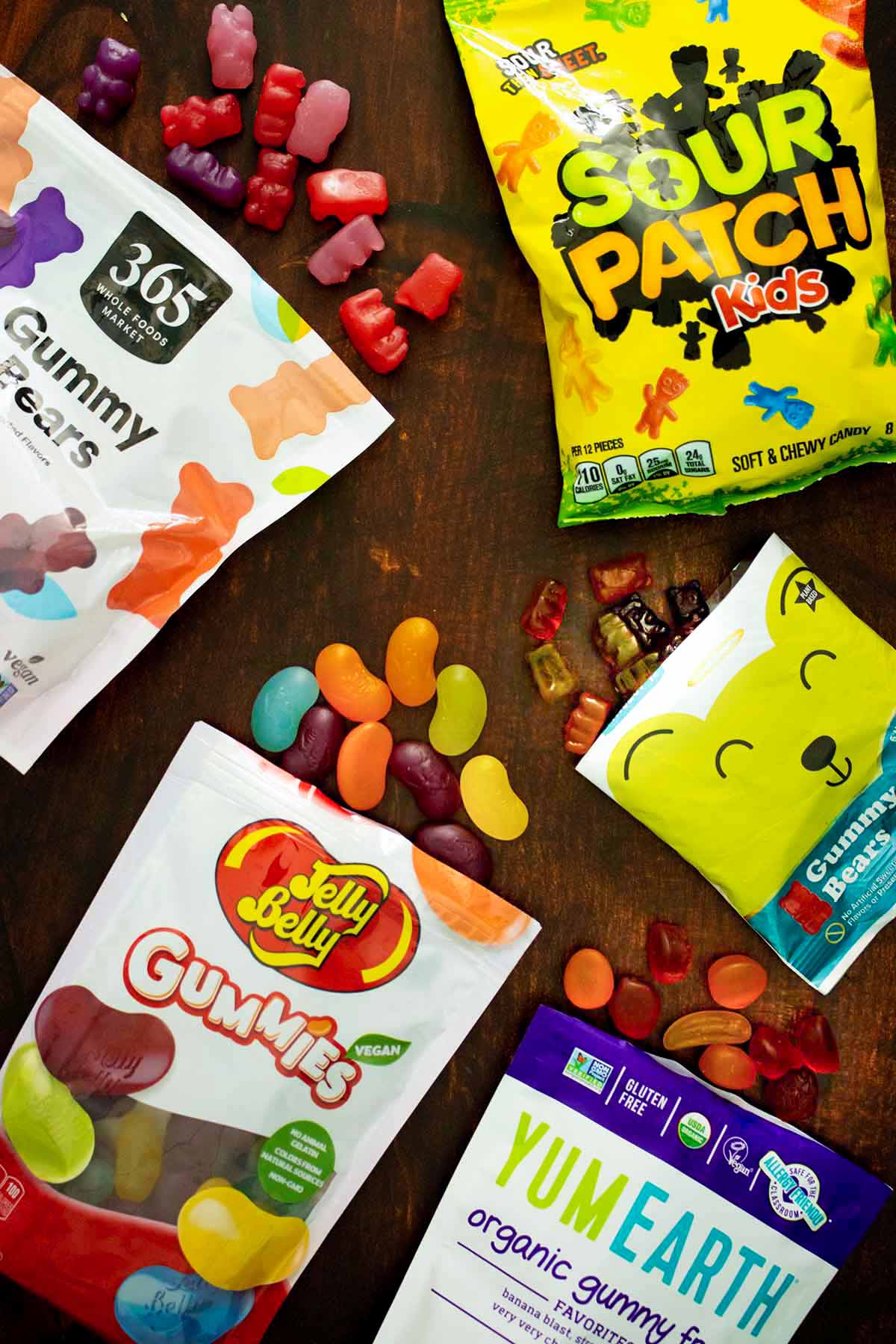 array of vegan gummy candy options on a wooden table