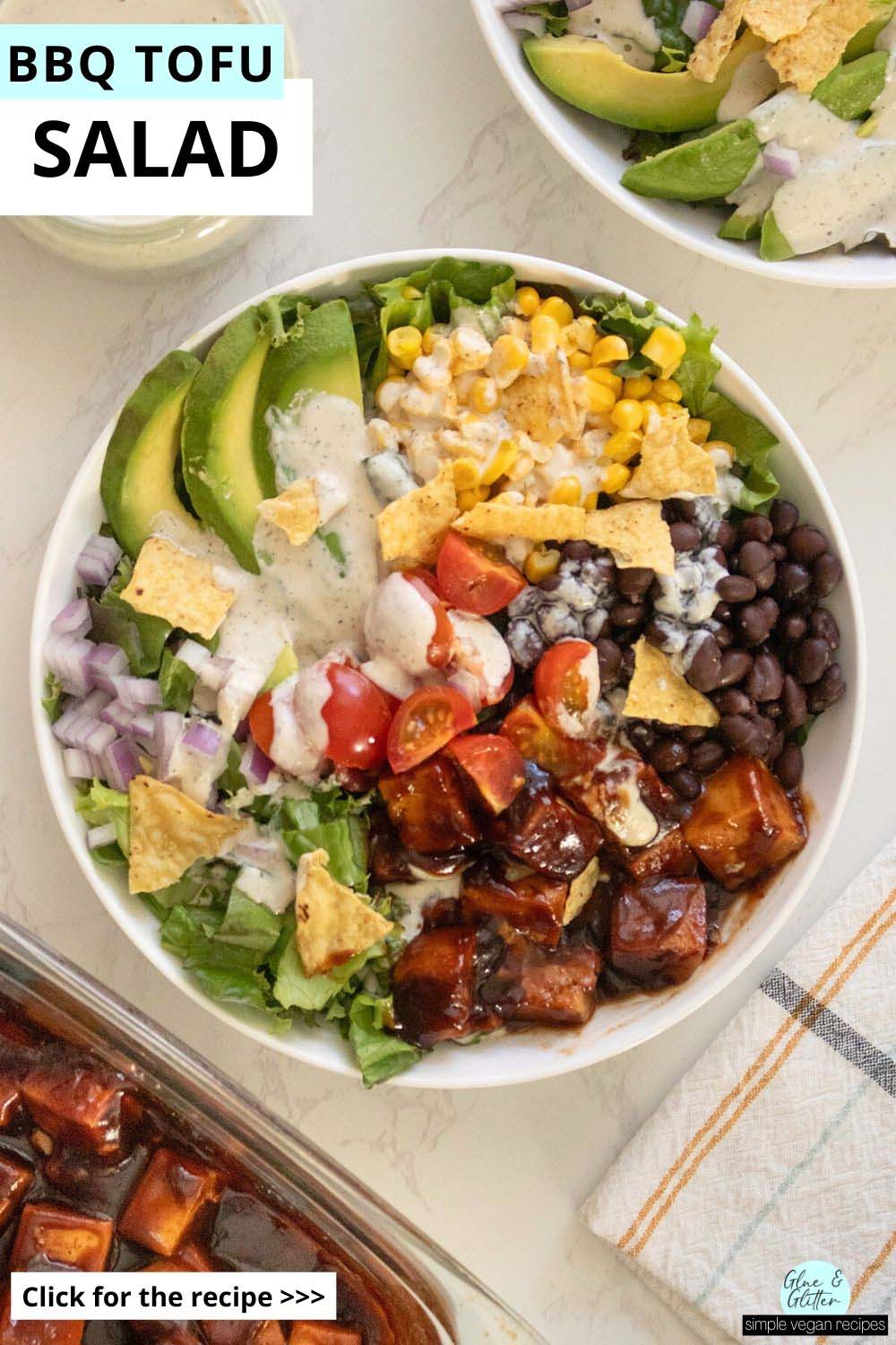 bbq tofu salad with avocado, beans, corn, tomato, and ranch dressing in bowls on a white table, text overlay