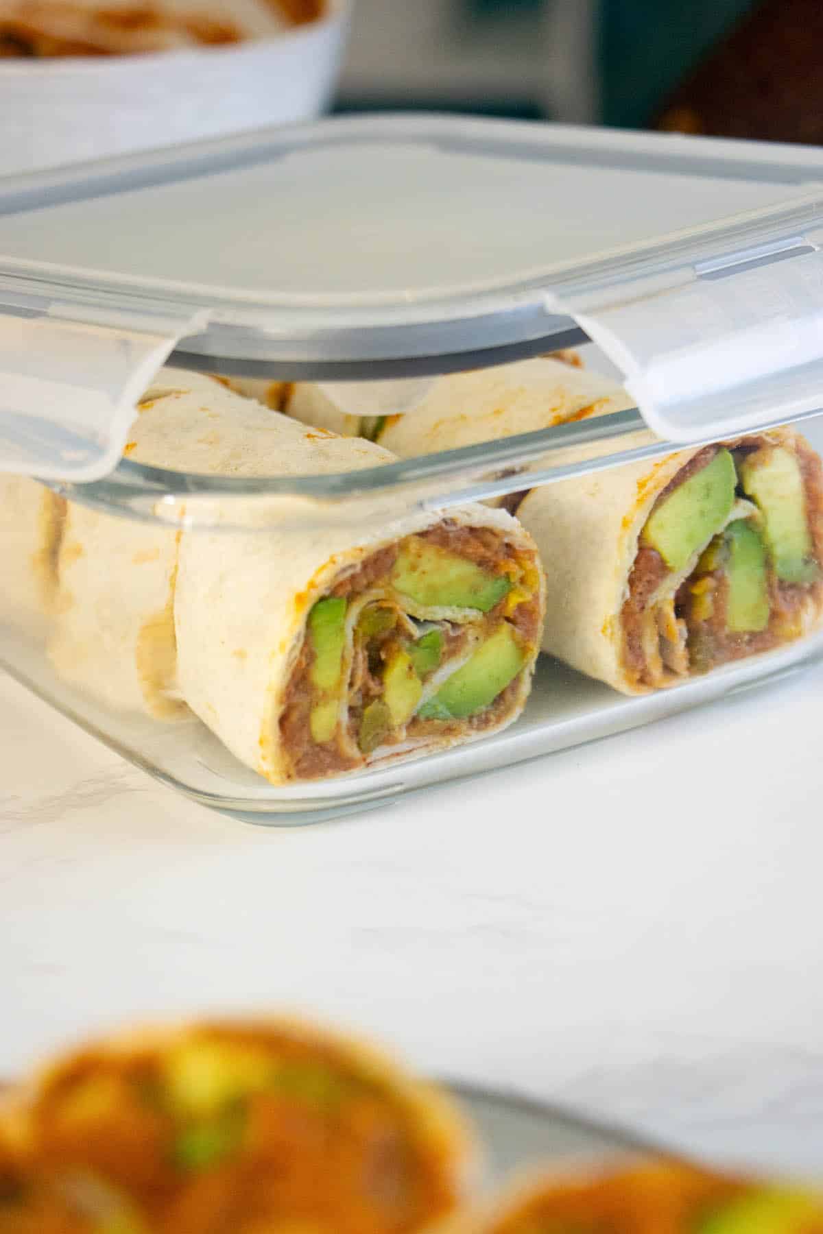 vegan rollups with beans and avocado packed in a meal prep lunchbox