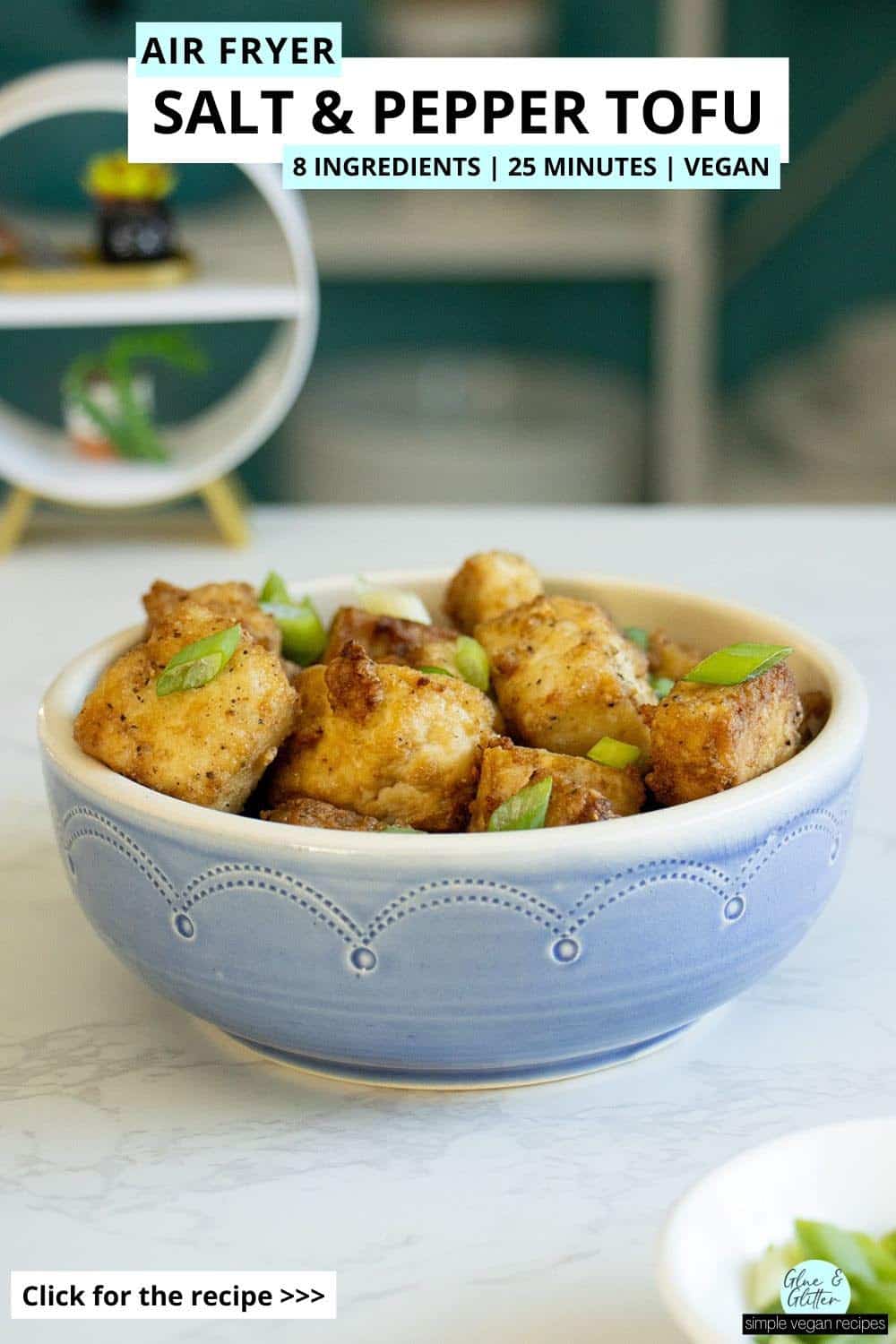 air fryer salt and pepper tofu in a bowl with green onions on top, text overlay