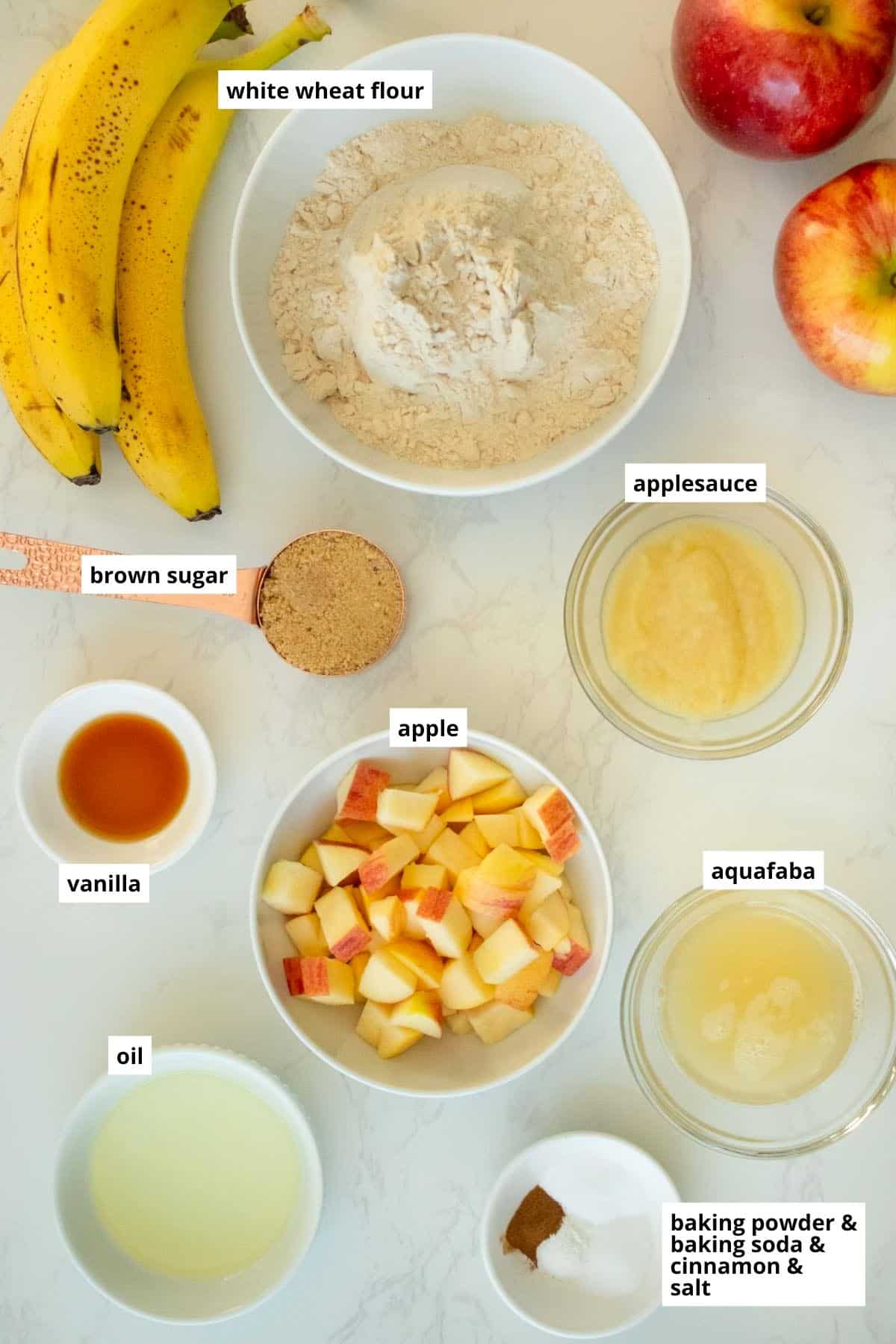 apples, bananas, and other muffin ingredients on a white table