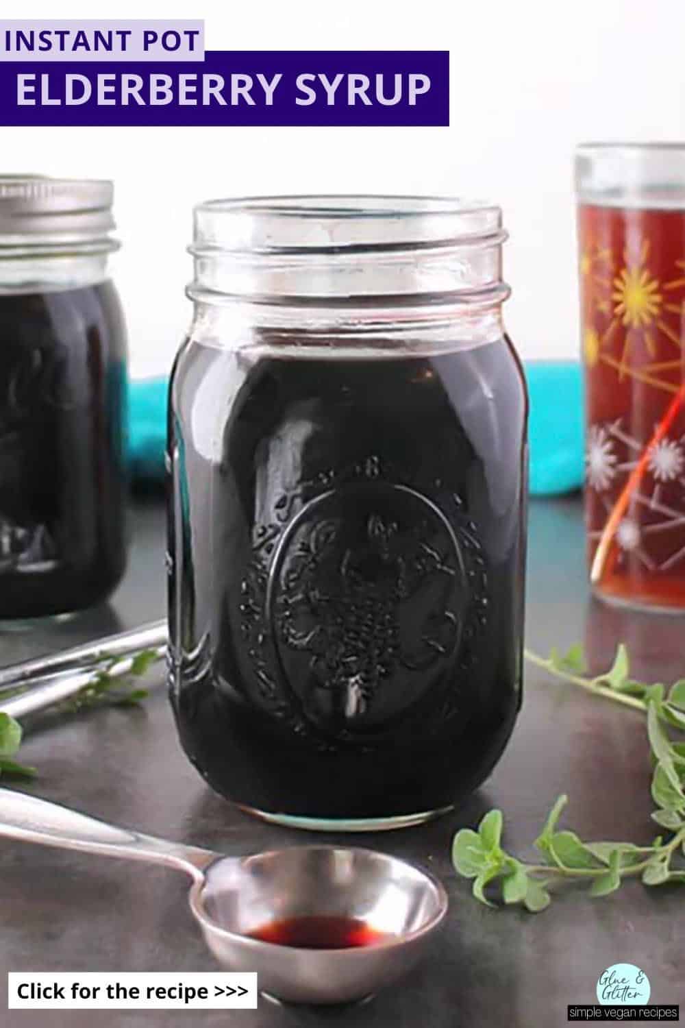 jars of instant pot elderberry syrup with a drink made from the syrup in the background, text overlay