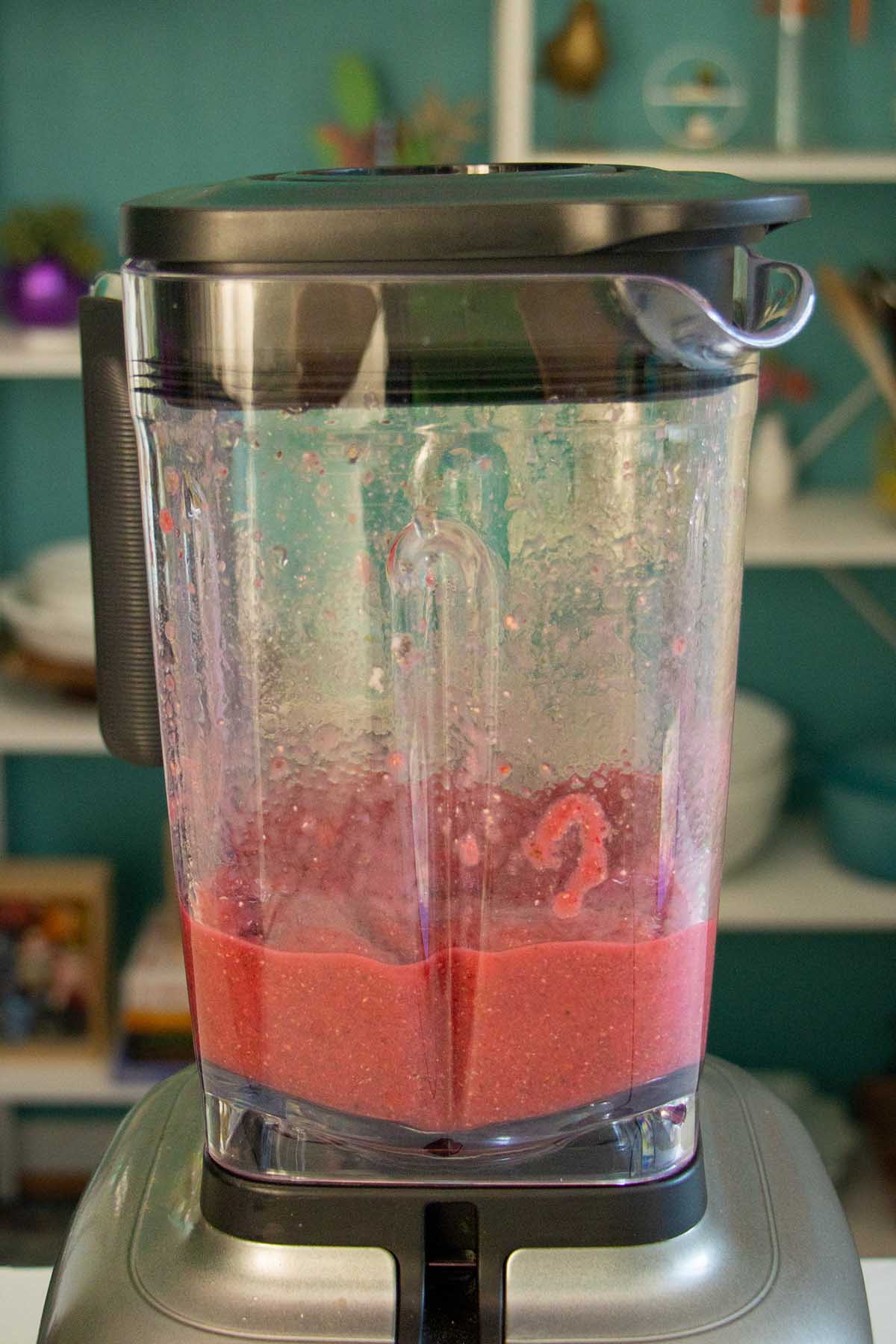 banana and raspberry smoothie in the blender after blending