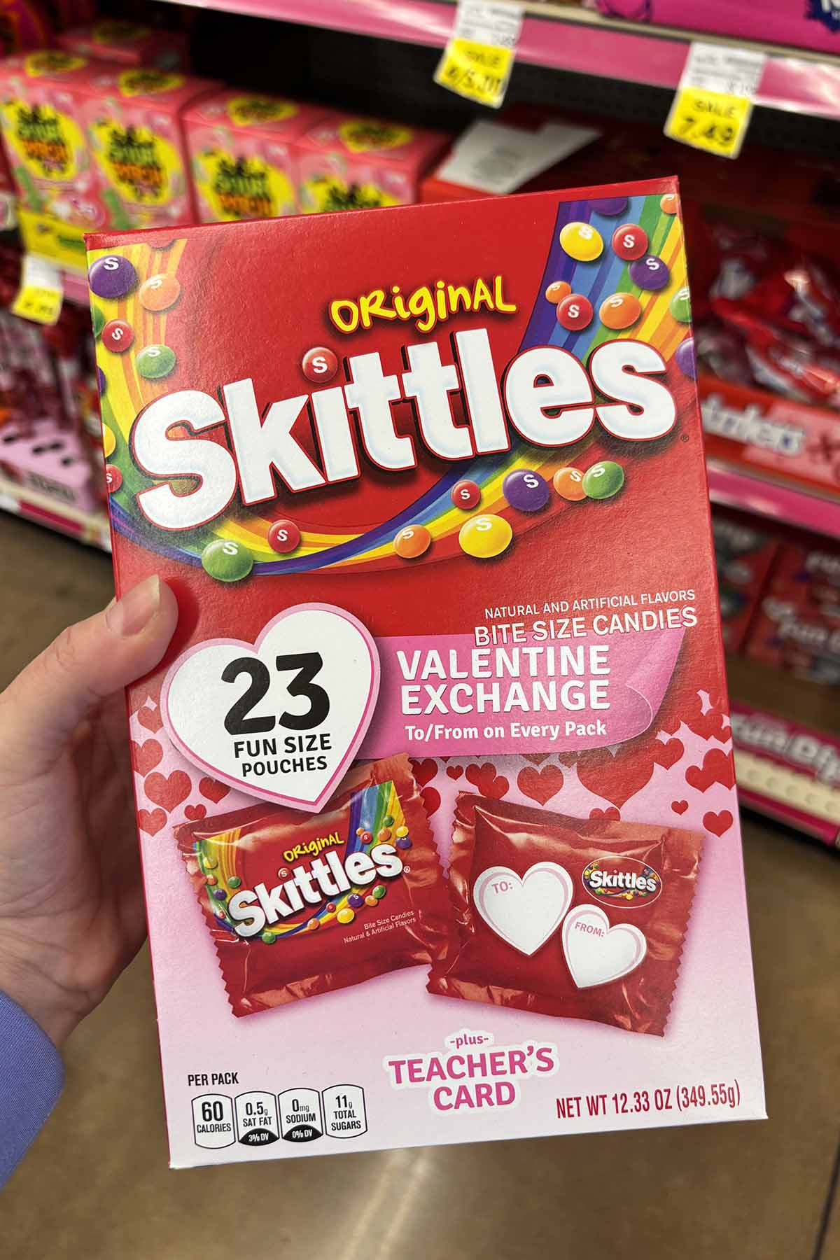 hand holding a box of Skittles Valentines