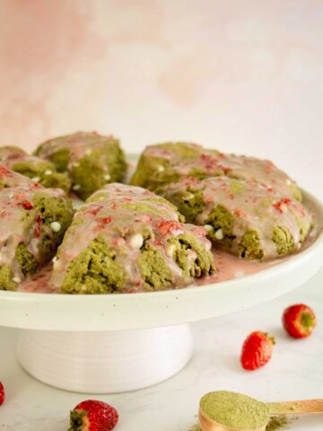 matcha scones on a serving tray with strawberry glaze