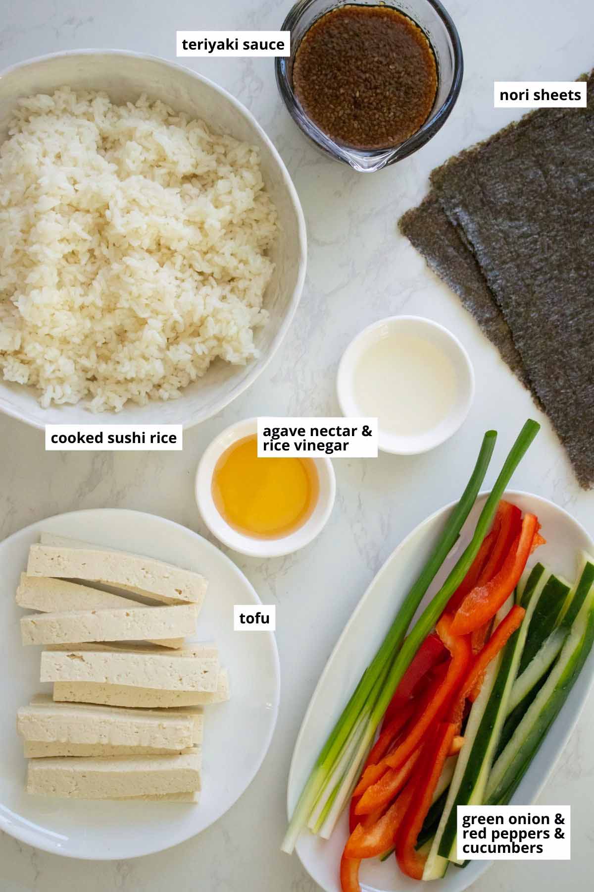 tofu, rice, teriyaki sauce, and veggies in bowls on a white table
