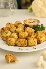 cauliflower tots on a plate with dipping sauce