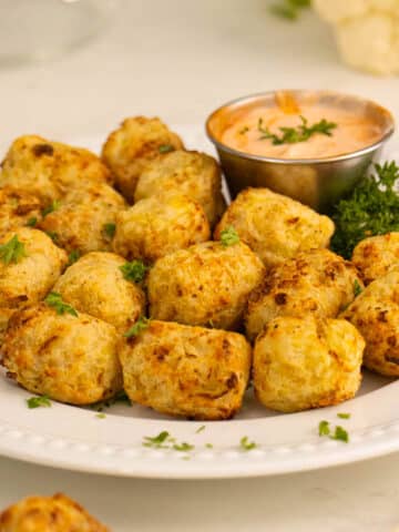 cauliflower tots on a plate with dipping sauce