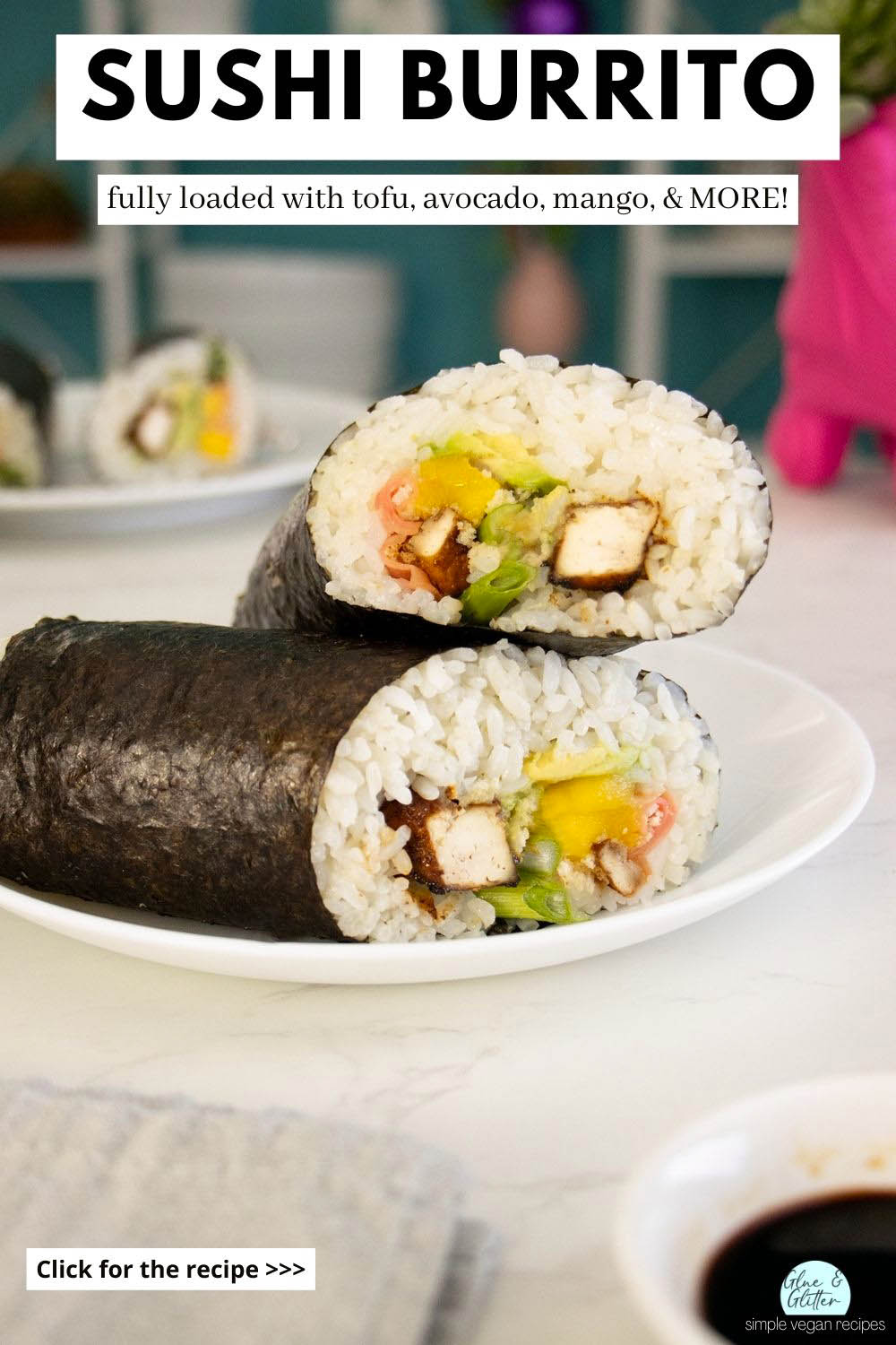vegan sushi burrito sliced in half and stacked on a white plate, text overlay