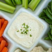 vegan dill dip with vegetables in a sectioned serving platter