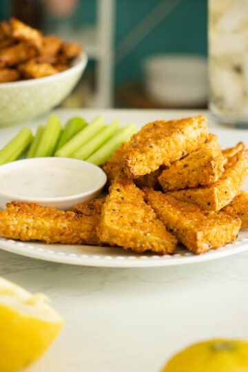 vegan lemon pepper wings on a plate with celery and ranch