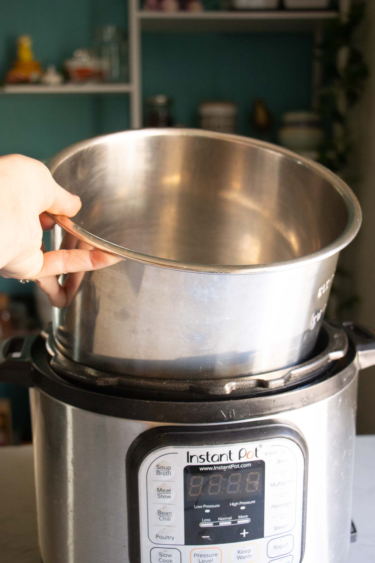 hand removing the inner pot from an Instant Pot